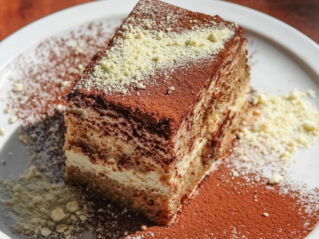 Slice of tiramisu dusted with cocoa, plated at Kingfishers in Maple Ridge